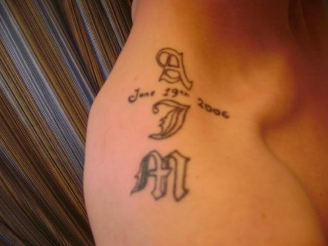 Tattoo of my son's initials and his DOB. Looks like a cross when standing 